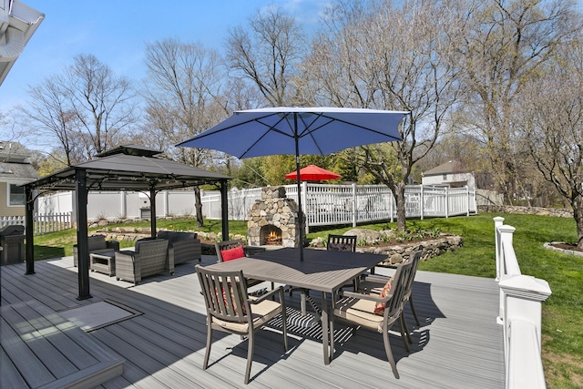 deck featuring an outdoor living space with a fireplace, a fenced backyard, a gazebo, and outdoor dining space