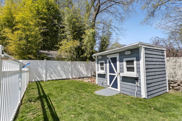 view of shed with a fenced backyard