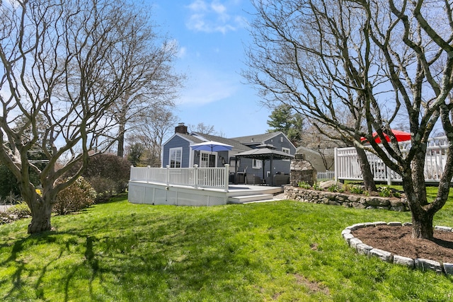 view of yard with a gazebo and a wooden deck