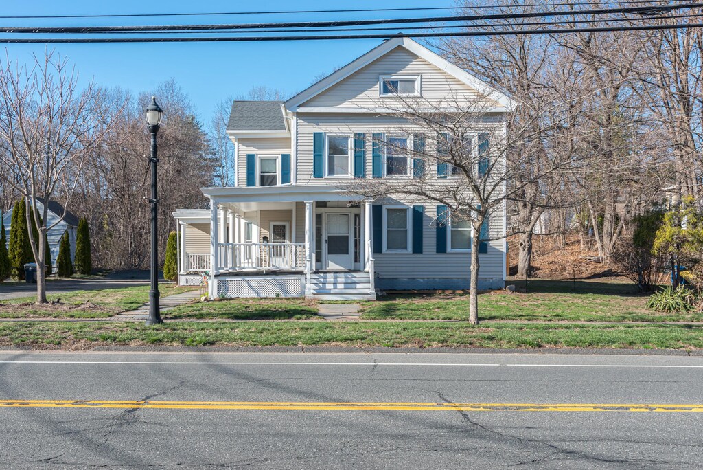 view of front of house with a porch and a front yard