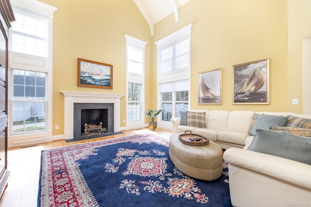 2 Pennington Dr Unit 2, Simsbury, CT 06070 - living room with high vaulted ceiling, a fireplace with flush hearth, wood finished floors, plenty of natural light, and baseboards