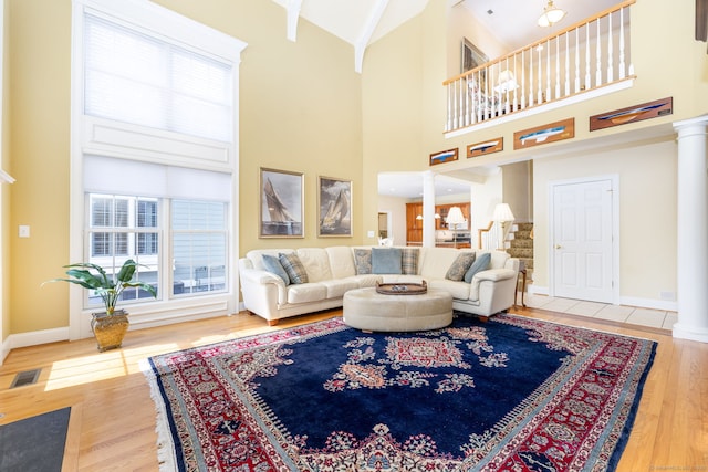 2 Pennington Dr Unit 2, Simsbury, CT 06070 - living room featuring decorative columns, baseboards, wood finished floors, a high ceiling, and stairway