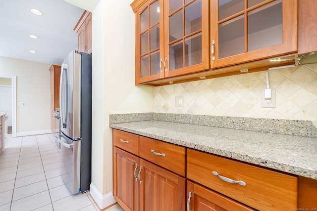 2 Pennington Dr Unit 2, Simsbury, CT 06070 - kitchen with freestanding refrigerator, baseboards, backsplash, light tile patterned floors, and light stone countertops