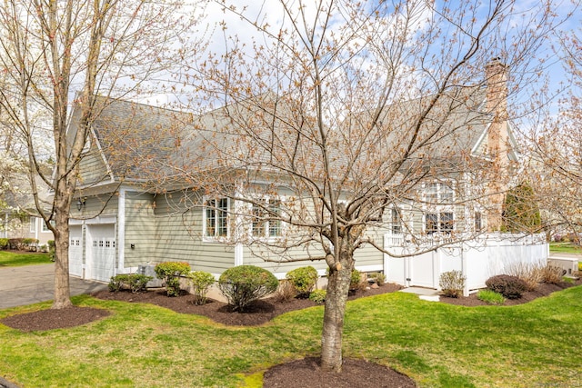 2 Pennington Dr Unit 2, Simsbury, CT 06070 - view of front of property with asphalt driveway, a front lawn, a chimney, and a shingled roof