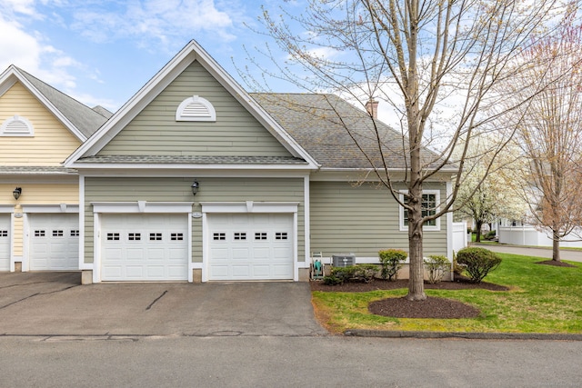 2 Pennington Dr Unit 2, Simsbury, CT 06070 - view of front facade with asphalt driveway, a garage, roof with shingles, central AC unit, and a chimney