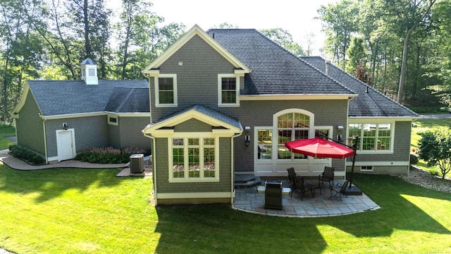 301 Fox Hopyard Rd, East Haddam, CT 06423 - back of property featuring a patio, a yard, roof with shingles, and entry steps