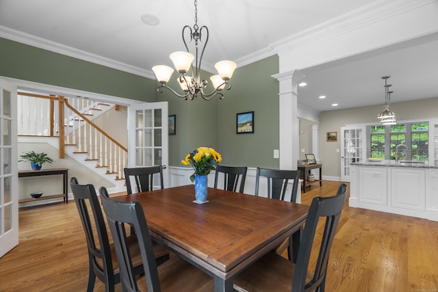 301 Fox Hopyard Rd, East Haddam, CT 06423 - dining space featuring light wood finished floors, ornamental molding, decorative columns, stairway, and french doors