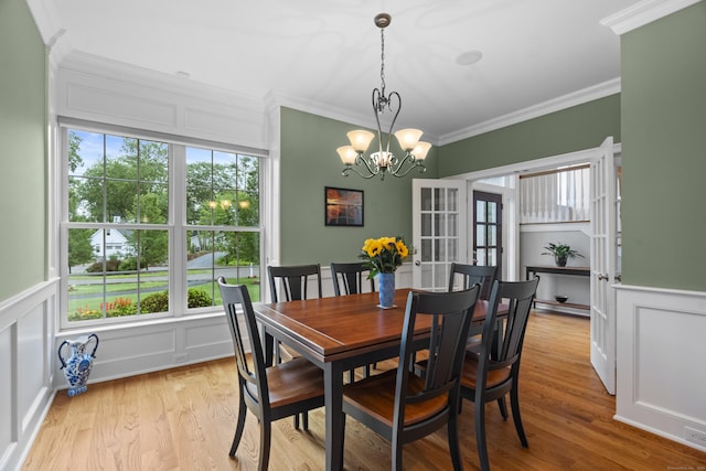 301 Fox Hopyard Rd, East Haddam, CT 06423 - dining space with a decorative wall, healthy amount of natural light, ornamental molding, a chandelier, and light wood finished floors