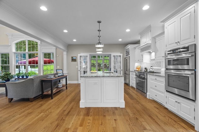 301 Fox Hopyard Rd, East Haddam, CT 06423 - kitchen featuring high end appliances, white cabinetry, a center island with sink, backsplash, and recessed lighting