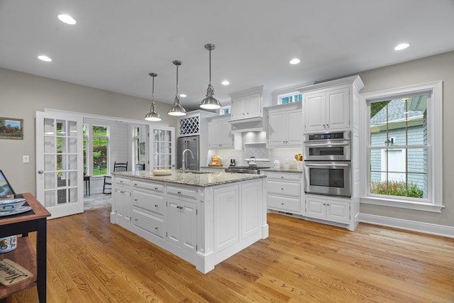 301 Fox Hopyard Rd, East Haddam, CT 06423 - kitchen featuring appliances with stainless steel finishes, plenty of natural light, white cabinets, light wood-style floors, and recessed lighting