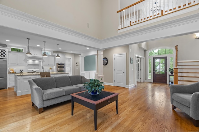 301 Fox Hopyard Rd, East Haddam, CT 06423 - living room featuring decorative columns, a towering ceiling, light wood-style floors, stairs, and recessed lighting