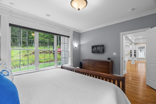 301 Fox Hopyard Rd, East Haddam, CT 06423 - bedroom with crown molding, wood finished floors, and ornate columns