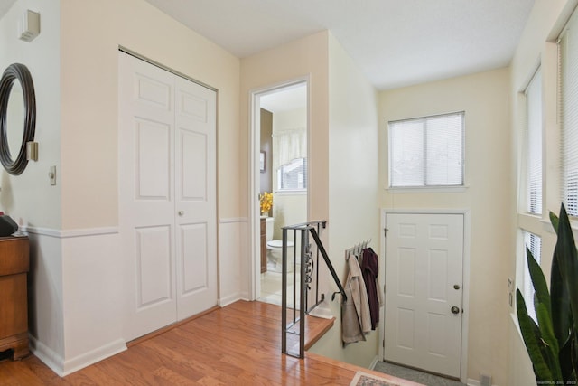 foyer with baseboards and light wood finished floors