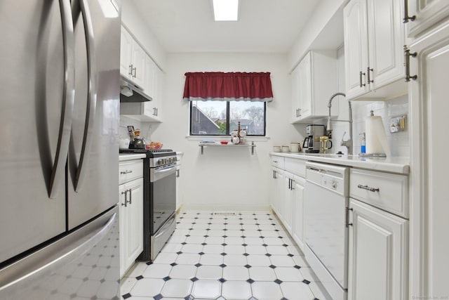 kitchen with appliances with stainless steel finishes, light countertops, white cabinetry, and under cabinet range hood