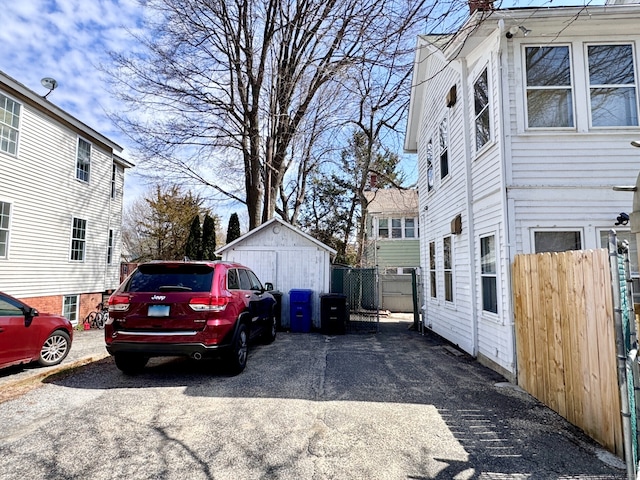 view of property exterior featuring fence and an outdoor structure