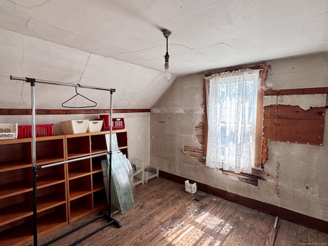 additional living space with hardwood / wood-style flooring and lofted ceiling