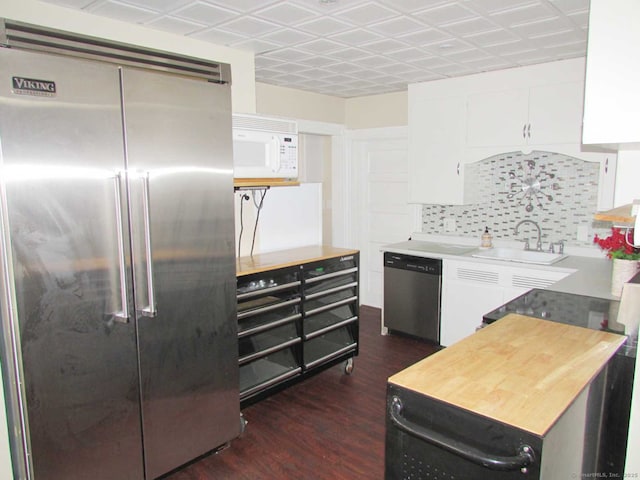 kitchen with a sink, white cabinetry, backsplash, and appliances with stainless steel finishes