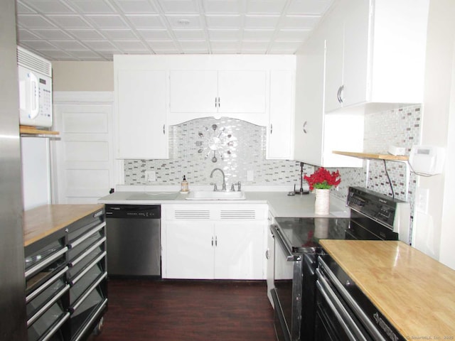 kitchen with a sink, black range with electric stovetop, tasteful backsplash, stainless steel dishwasher, and white cabinets
