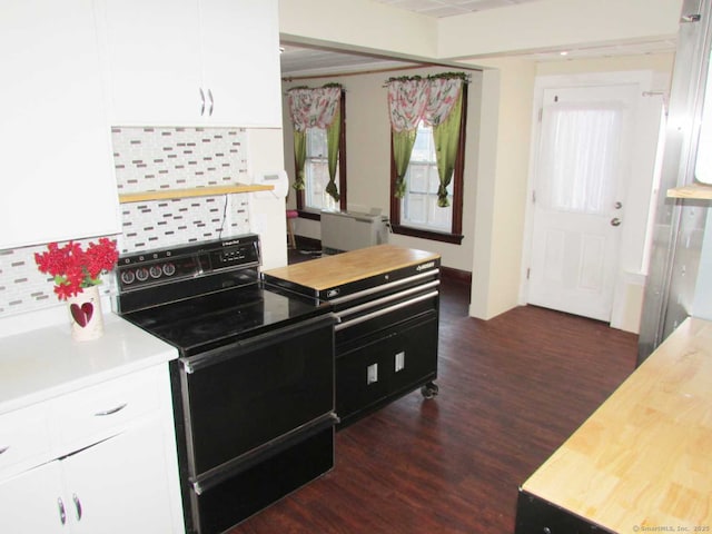 kitchen with dark wood-style floors, white cabinetry, light countertops, and black range with electric stovetop