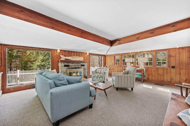 7 Ford Rd, Newtown, CT 06482 - carpeted living area with plenty of natural light, wood walls, a stone fireplace, and beam ceiling