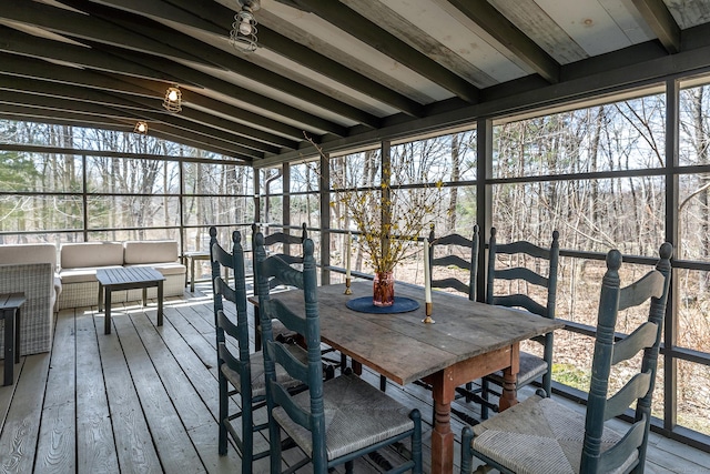 sunroom / solarium with beam ceiling, an outdoor hangout area, and a healthy amount of sunlight