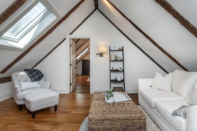 living room with baseboards, lofted ceiling with skylight, and wood finished floors