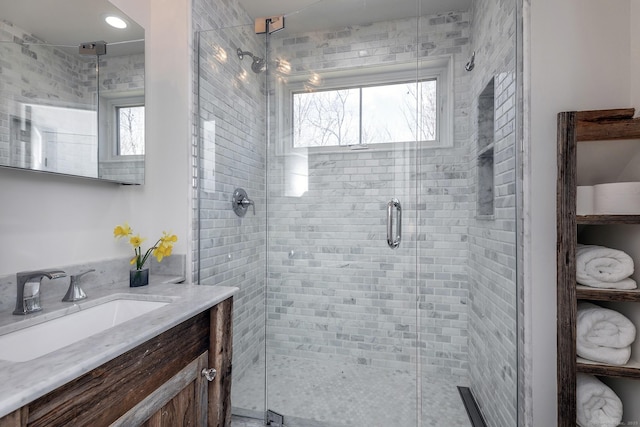 bathroom featuring a stall shower and vanity