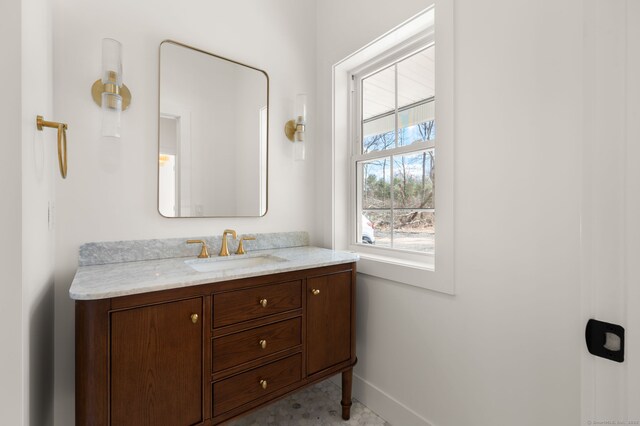 bathroom featuring baseboards and vanity