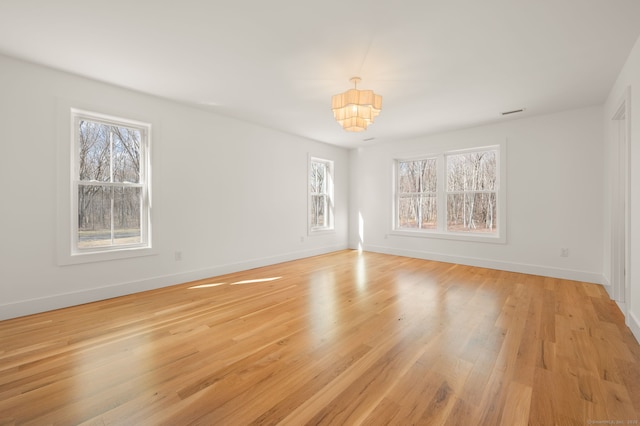 interior space featuring baseboards, light wood-style flooring, and a wealth of natural light