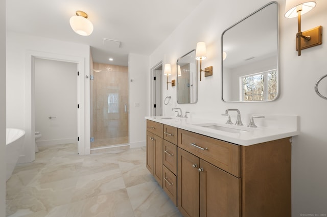 bathroom featuring a sink, double vanity, marble finish floor, baseboards, and a shower stall