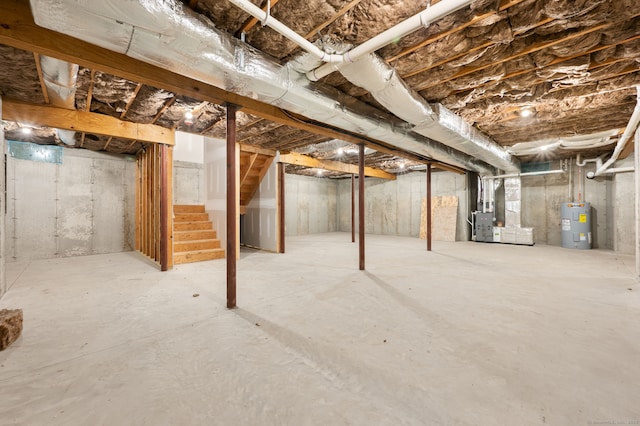 unfinished basement featuring heating unit, water heater, and stairway