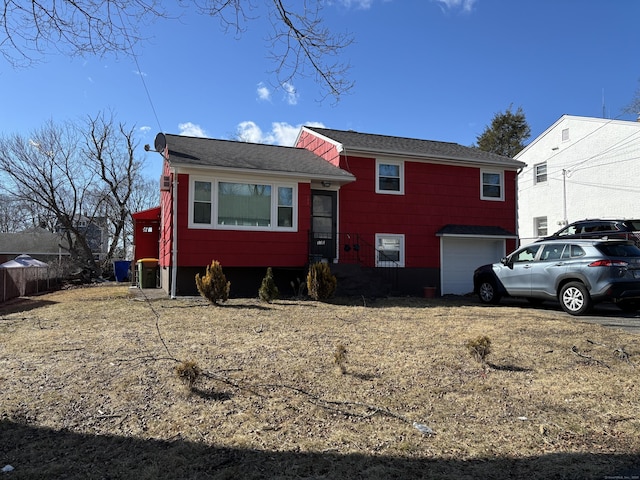 133 Traverse St, Waterbury, CT 06704 - tri-level home featuring roof with shingles and an attached garage