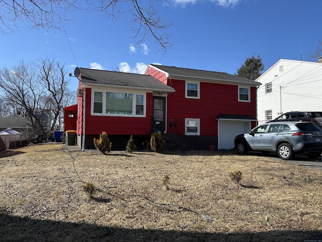 133 Traverse St, Waterbury, CT 06704 - tri-level home with a garage and roof with shingles