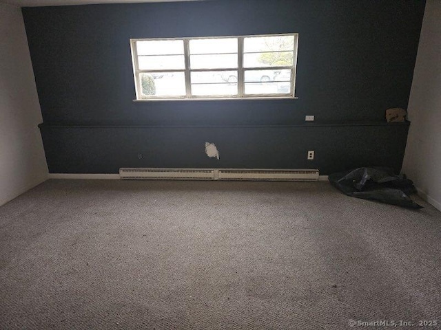 carpeted spare room with baseboard heating