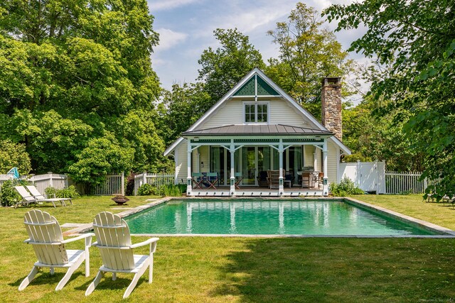 253 Tophet Rd, Roxbury, CT 06783 - back of house with a chimney, a fenced backyard, a metal roof, and view of wooded area