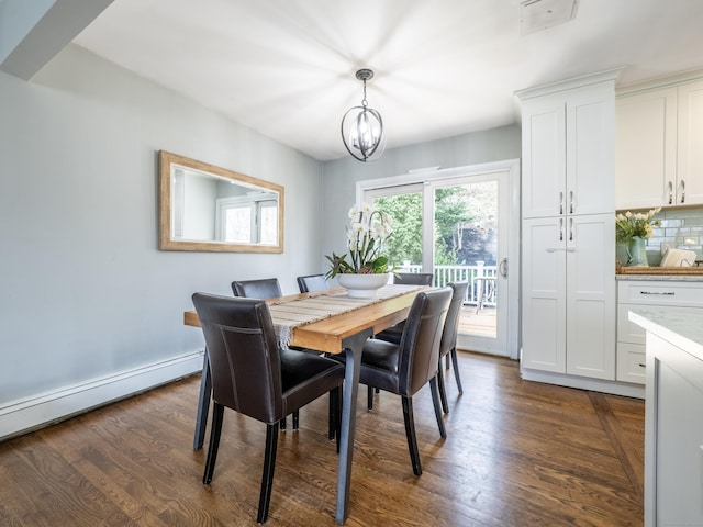 dining space with a baseboard heating unit, baseboards, a notable chandelier, and dark wood finished floors