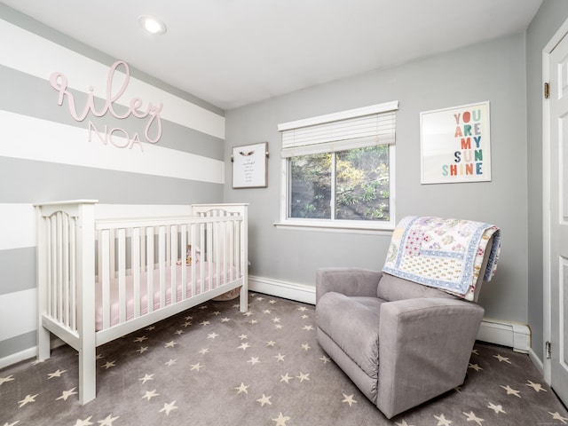 bedroom featuring baseboards, baseboard heating, carpet flooring, and a nursery area
