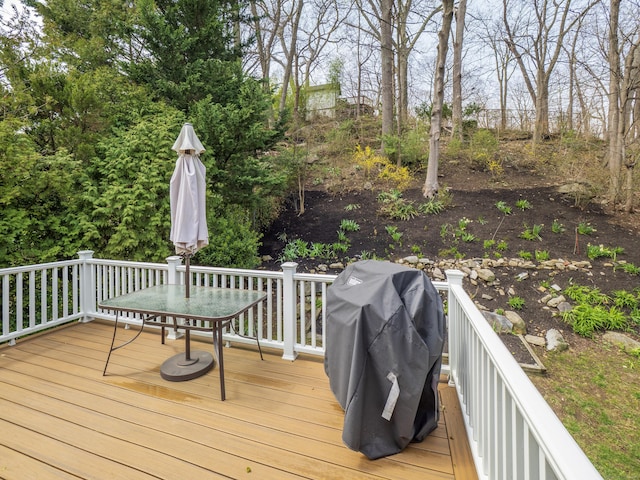 wooden deck with grilling area and outdoor dining space