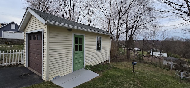 view of outbuilding with an outbuilding and fence
