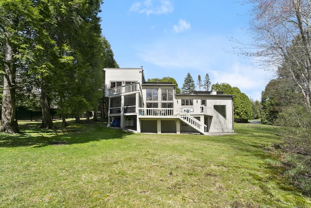 back of property featuring a lawn and stairs