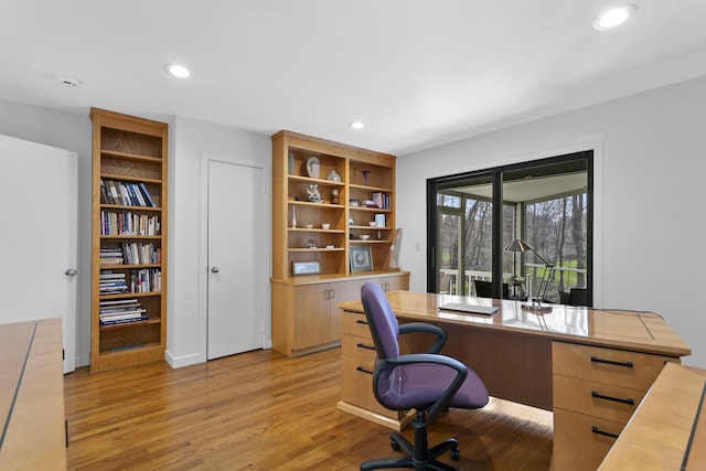 office area with light wood-type flooring and recessed lighting