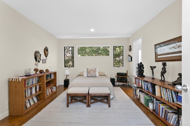 bedroom with baseboards, recessed lighting, and wood finished floors