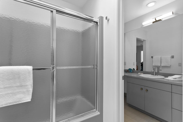 full bath with tile patterned flooring, vanity, and a stall shower