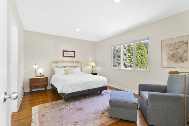 bedroom with baseboards, recessed lighting, and wood finished floors