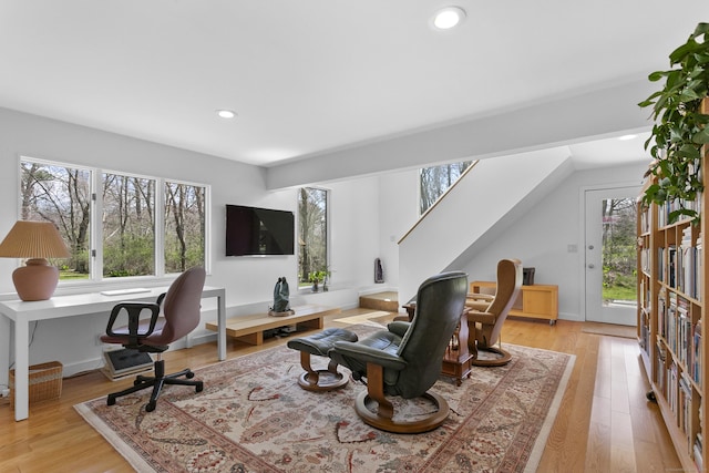 office area with light wood finished floors and recessed lighting