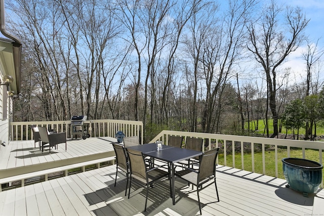 wooden terrace featuring outdoor dining area