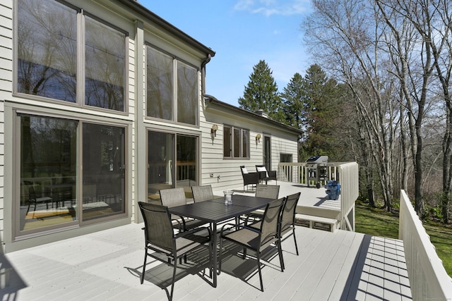 wooden terrace with outdoor dining space