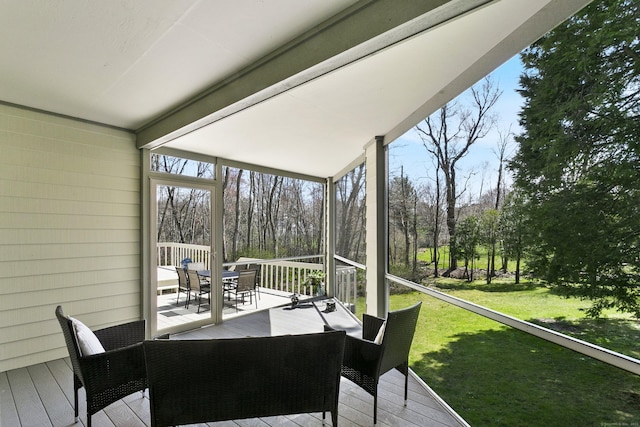 sunroom with outdoor dining area