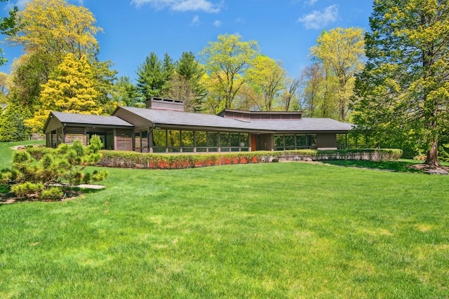 71 Boulderol Rd, Stamford, CT 06903 - rear view of property featuring a lawn and a chimney