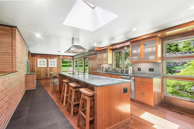 71 Boulderol Rd, Stamford, CT 06903 - kitchen with stainless steel dishwasher, ventilation hood, a large island, a skylight, and a breakfast bar area
